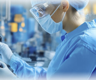 A scientist wearing PPE.